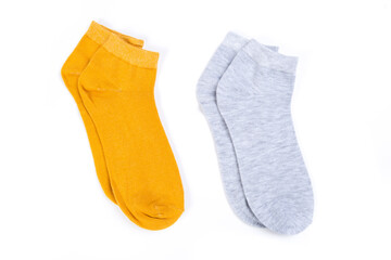 two pairs of colored short socks on a white background, top view
