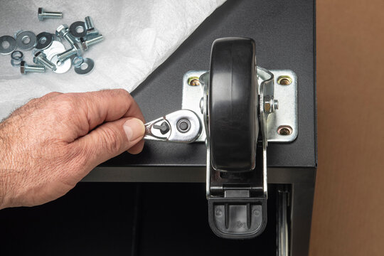 Hand Installing A Caster On A New Tool Chest