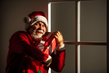 Christmas interior. ready for xmas party. celebrate winter holiday. funny man wear santa claus coat and hat. shopping. Merry Christmas and Happy Holidays. New year is coming. happiness and joy