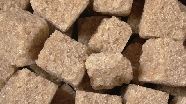 Rotation of sugar lumpy close-up. Brown sugar. Sugar cubes.