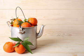 Tangerines with leaves on a wooden background