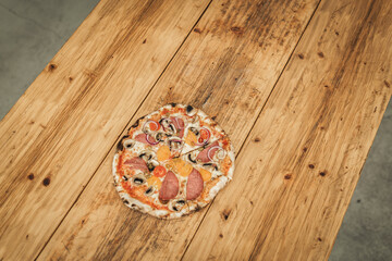 Fototapeta na wymiar delicious home made pizza with salami mushrooms and onions 