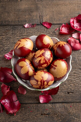 Easter eggs dyed with onion peels with a pattern of fresh herbs