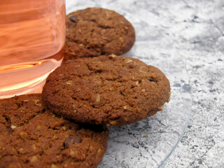 Homemade chocolate brown butter cookies on a transparent saucer and dogwood compote.