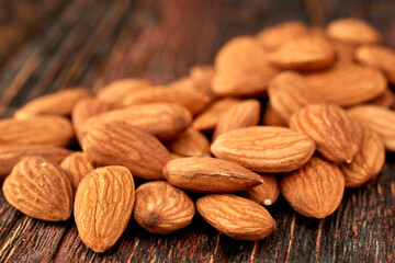 Almond kernels lie on a dark background.Selective focus.Salted almonds.