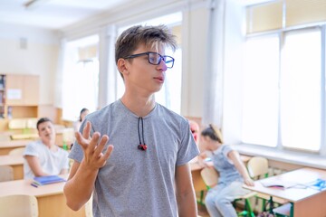 Smart teenager student male taking exam, answers lesson