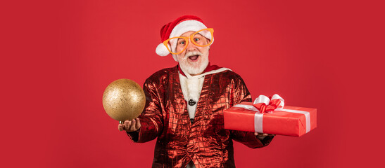 Being surprised. ready for xmas party. celebrate winter holiday. funny man wear santa claus coat and hat. shopping. Merry Christmas and Happy Holidays. New year is coming. happiness and joy