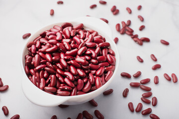 Red beans in a white bowl on a light background