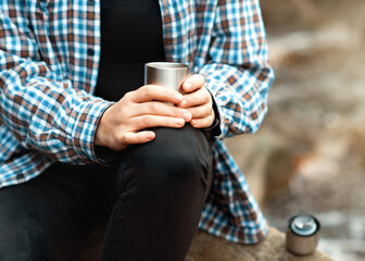 woman drinking coffee in the forest