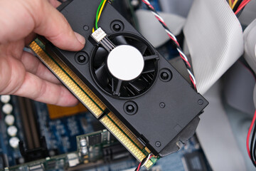 Obraz premium Hand of a tachnician, rapairman holding part of a computer needed to be replaced or upgraded