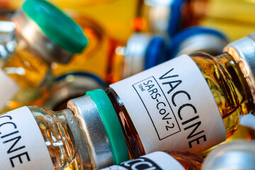 Vaccine vials of Sars-cov-2 on table in laboratory .