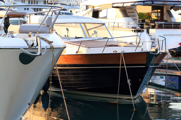 A bow of a luxury yacht moored in marina, expensive yachts at the pier