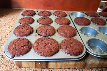 A tray full of chocolate zucchini muffins