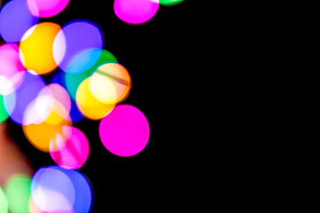 Colofrul festive lights on a Christmas tree blurred. Isolated black background for New Year ads