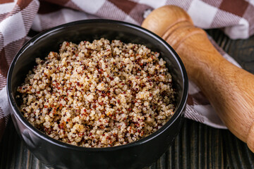 bowl of healthy quinoa on a dark wooden rustic background