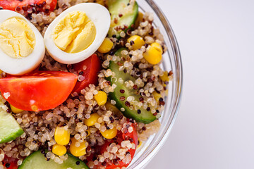 bowl of healthy quinoa with vegetables on a white background