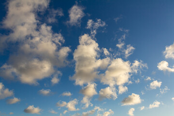 Striking fluffy clouds in the blue sky. Background for designers