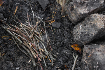 How to make a fire. Burning brushwood. Small branches for a fire. Smoke without fire. How does the fire start? Boy scout skills. Autumn background.