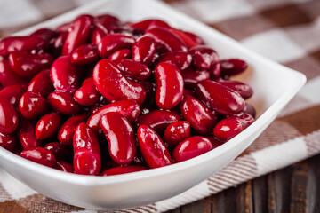 canned red kidney beans on a dark wooden rustic background