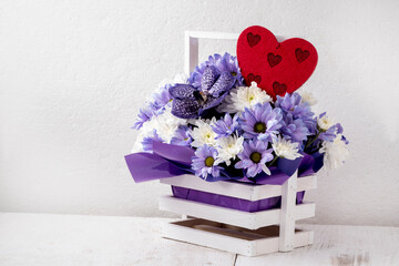 Greeting card with a basket of purple orchids and white chrysanthemums with hearts. Welcome Wallpapers for Anniversary, Valentine's Day, Mother's Day, Birthday