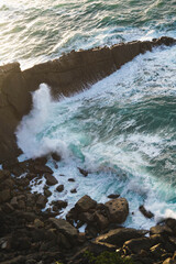 Waves breaking in the coastal cliffs during sunset