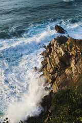 Waves breaking in the coastal cliffs during sunset
