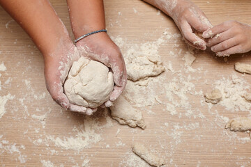 Kid you are playing and making dough.