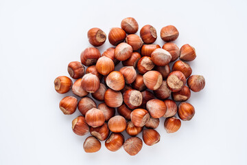 fresh natural hazelnuts on a white acrylic background