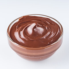 chocolate butter and hazelnuts on a white acrylic background