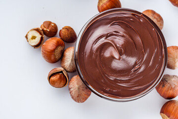 chocolate butter and hazelnuts on a white acrylic background