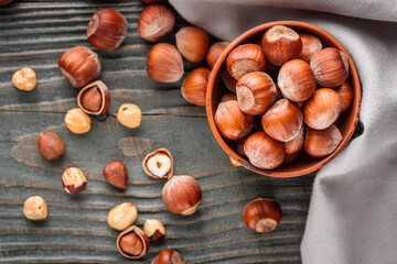 fresh natural hazelnuts on a dark wooden rustic background