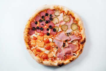 Italian pizza four seasons with ham, cucumber, olives and salmon.  Italian fast food delivery.