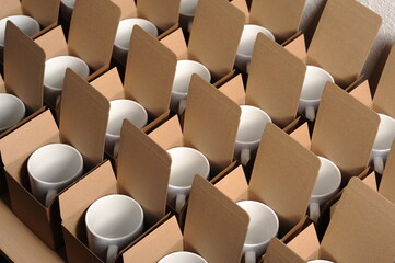 Fototapeta premium white mugs in craft cardboard boxes