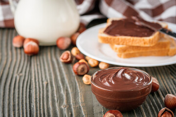 toasts with chocolate butter on a dark wooden rustic background