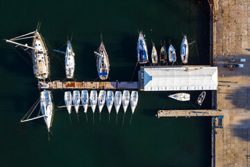 Aerial view in a lot yachts in a port on a peaceful sea background.
