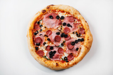 Italian pizza with salami, ham, olives and mushrooms.  Italian fast food delivery.