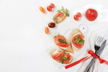 Caprese Bruschetta toast with mozzarella cheese, cherry tomatoes and fresh garden Basil.Traditional Italian food, healthy natural Breakfast, cholesterol-free and GMO-free, space for text,