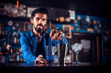 Bartender mixes a cocktail on the saloon