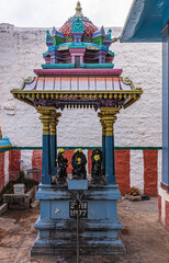 Kadirampura, Karnataka, India - November 4, 2013: Sri Murugan Temple. Black set of 9 statues called Navagraha represents the 9 planets under blue colorful stone baldachin. © Klodien