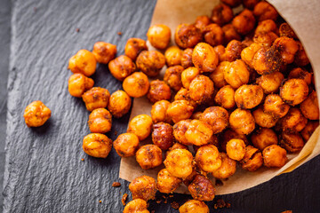 fried chickpeas on a dark stone background