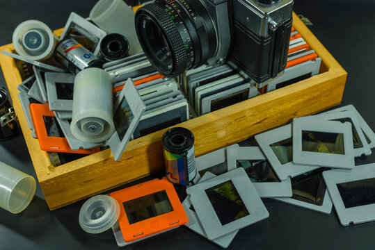 35mm Slide-Photos, An old analog camera and a wooden box with slides, out of focus, dias