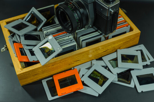 35mm Slide-Photos, An old analog camera and a wooden box with slides, out of focus, dias