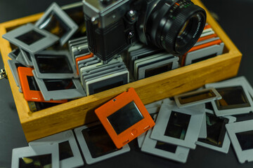 35mm Slide-Photos, An old analog camera and a wooden box with slides, out of focus, dias