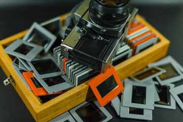 35mm Slide-Photos, An old analog camera and a wooden box with slides, out of focus, dias