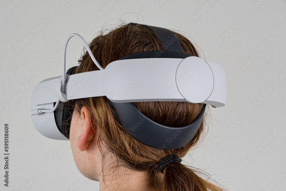 Wall mural young female wearing a vr headset