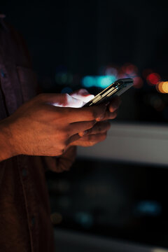 Close Up Of Caucasian Business Man Typing On Cellular Device Working Late At Night In Apartment 