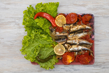 Fish stewed in vegetables with lemon. Culinary background with selective focus