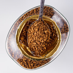 instant coffee granules on a white acrylic background