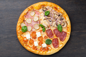 Italian pizza with melted mozzarella cheese, olives and sausage garnished with fresh vegetables and basil leaves