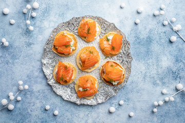 Blini with smoked salmon and sour cream, garnished with dill